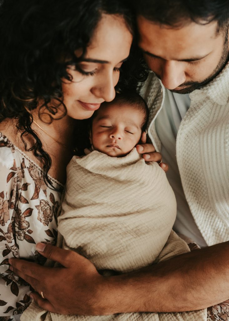Studio newborn photography in Auckland: Baby Niam showcases his perfect curls in a classic portrait.