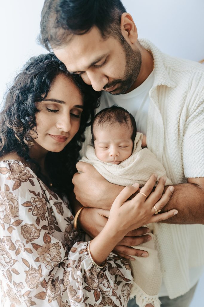 Newborn baby Niam sleeps peacefully, bathed in soft studio light during his Auckland photoshoot.
