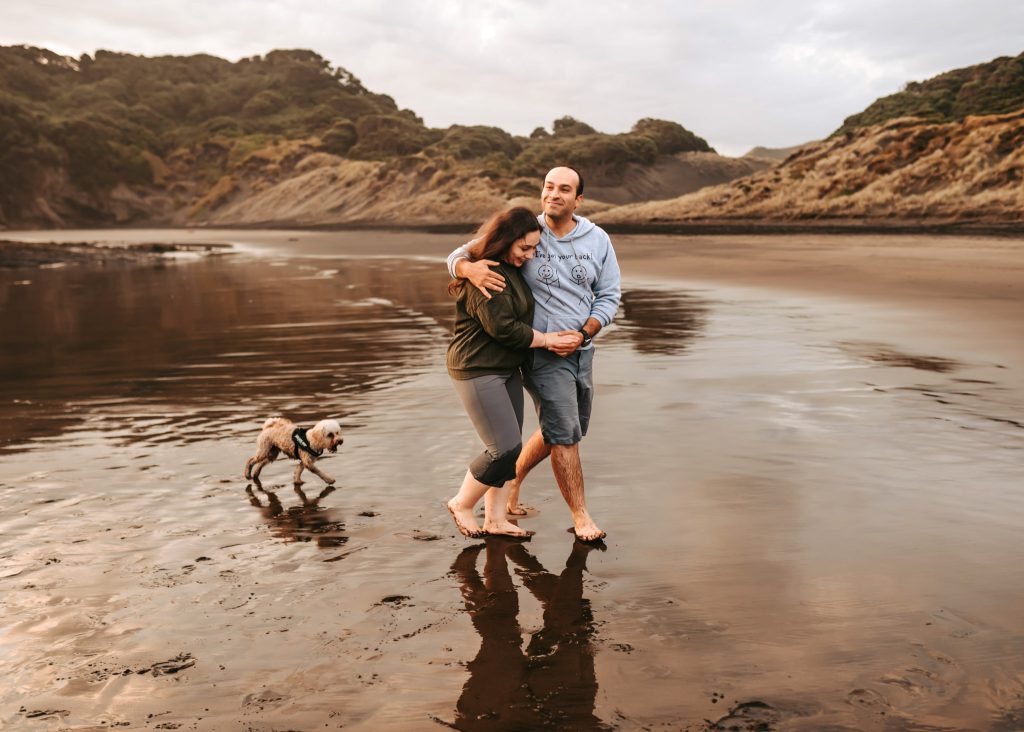 Auckland couple photoshoot: The dramatic landscape of Bethells Beach adds a touch of adventure to Mas and Huda's anniversary portraits.