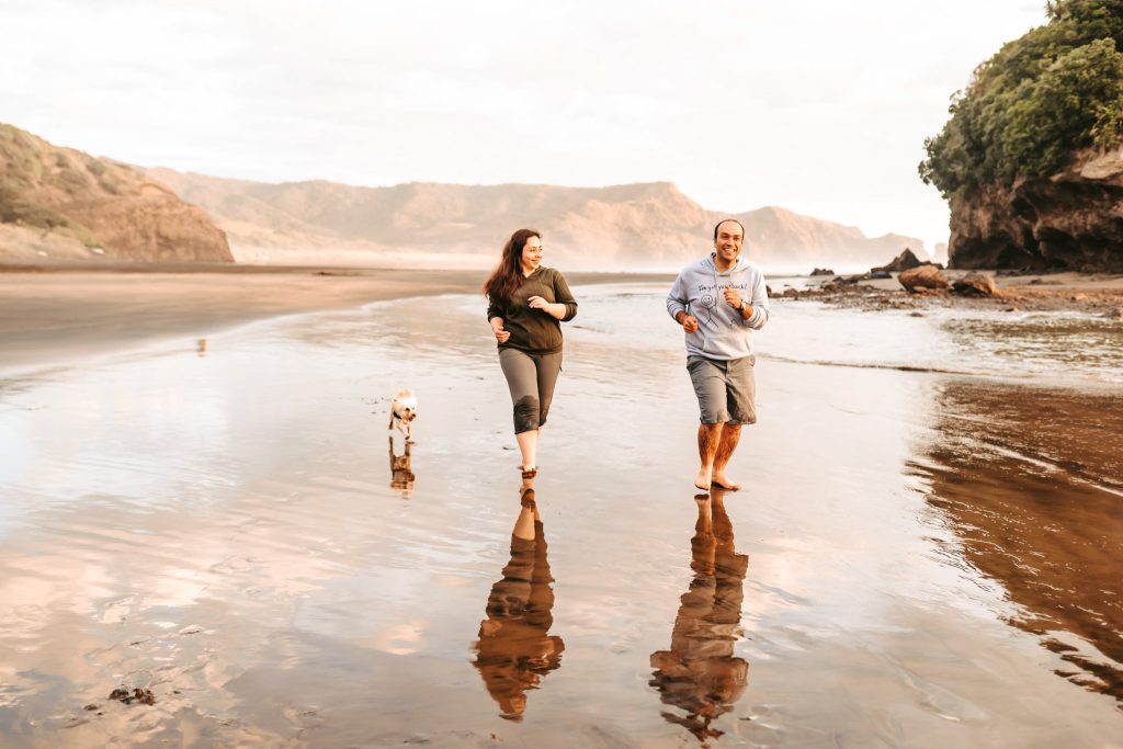 Love and laughter on the shore: Mas and Huda's anniversary shoot at Bethells Beach is filled with joy and connection.