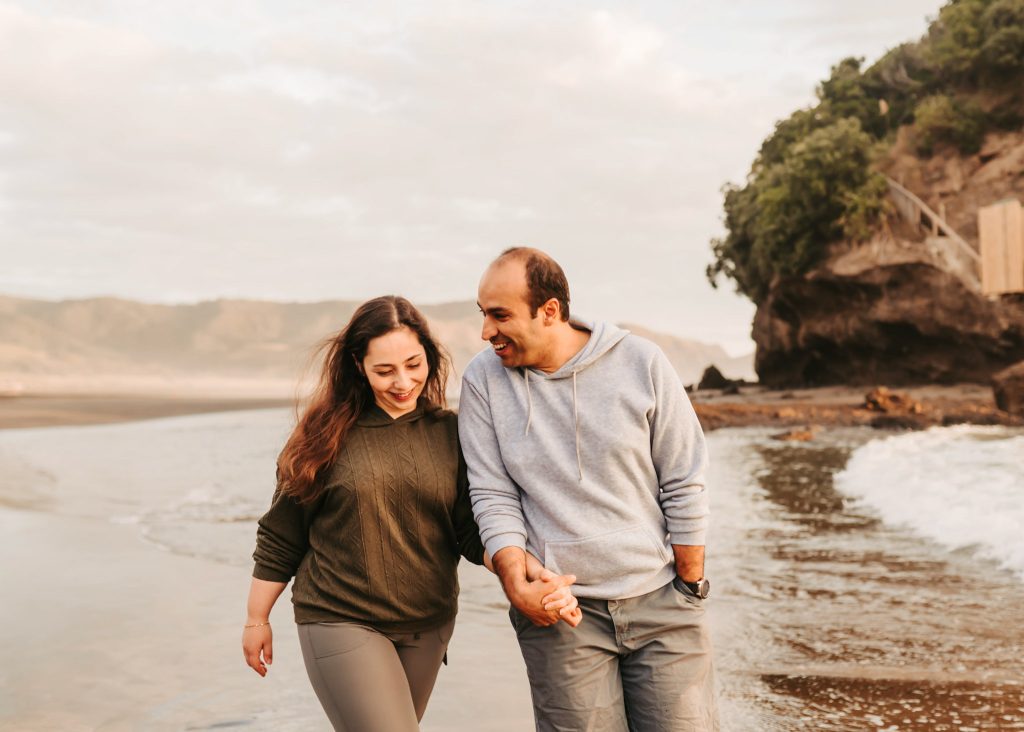 Auckland anniversary photography: The vastness of Bethells Beach creates a breathtaking backdrop for Mas and Huda's love story.