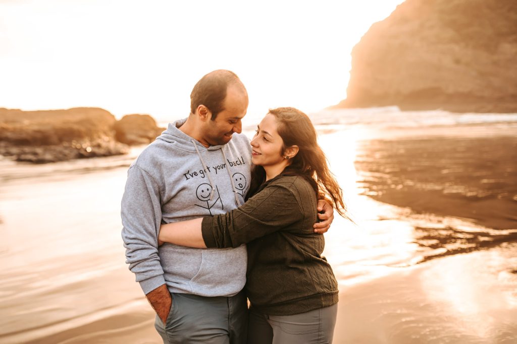 Bethells Beach couple photography: A romantic anniversary portrait captures Mas gazing lovingly into Huda's eyes.